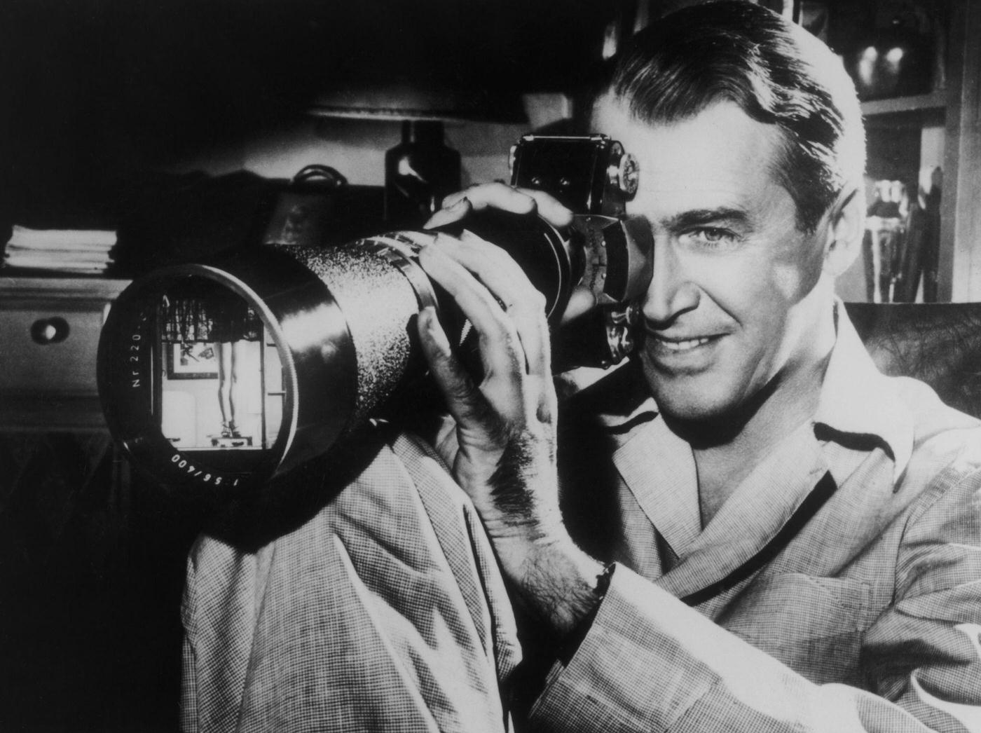 James Stewart focuses on a shapely pair of female legs in a scene from the film ‘Rear Window’, 1954.