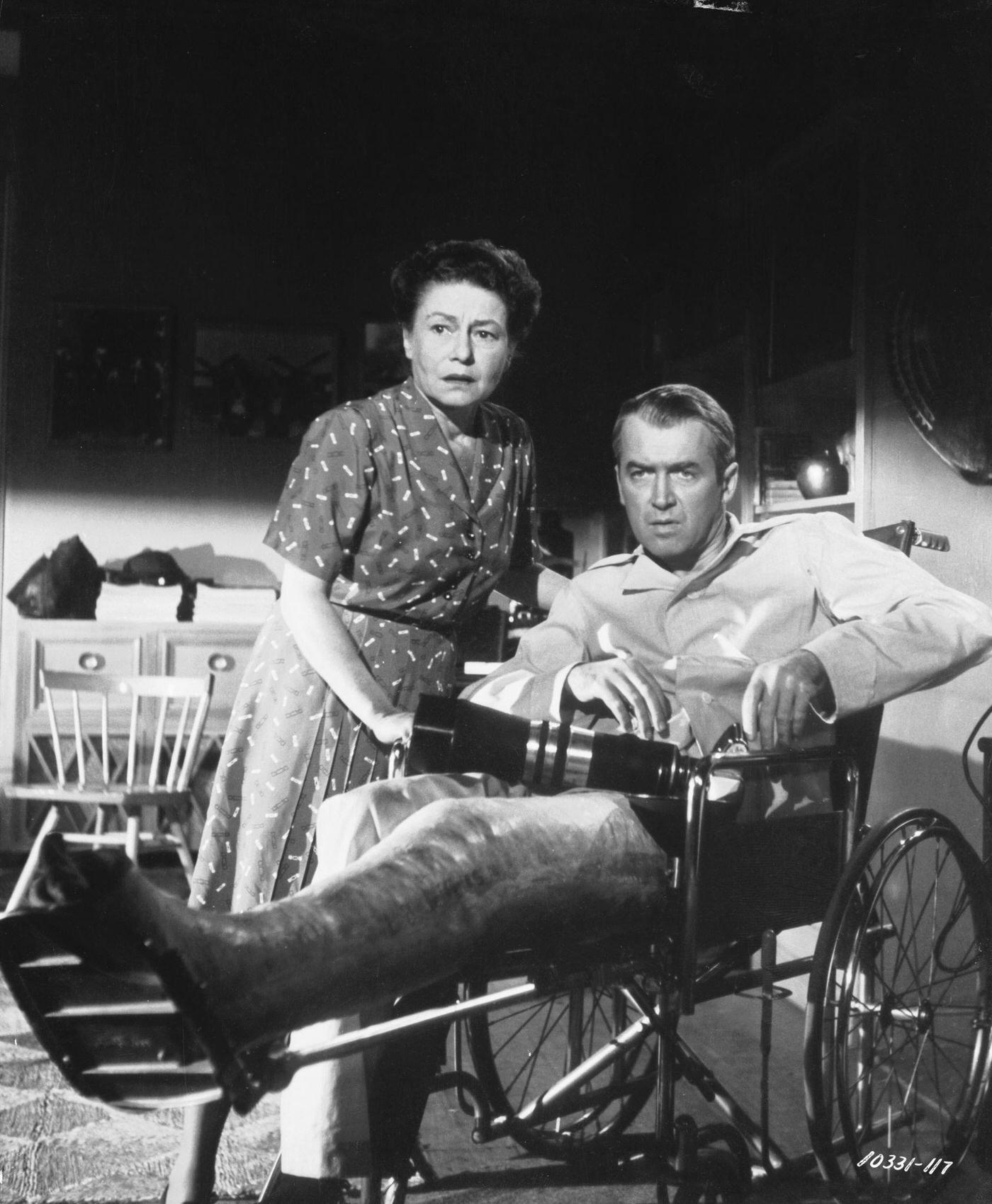 Wheelchair bound James Stewart with his nurse Thelma Ritter in a scene from Alfred Hitchcock’s ‘Rear Window’