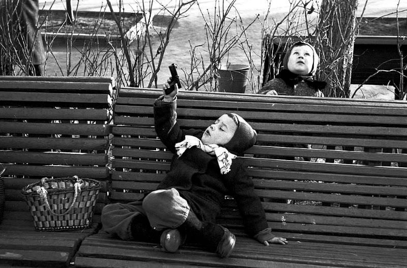 #58 A boy playing with a toy gun.