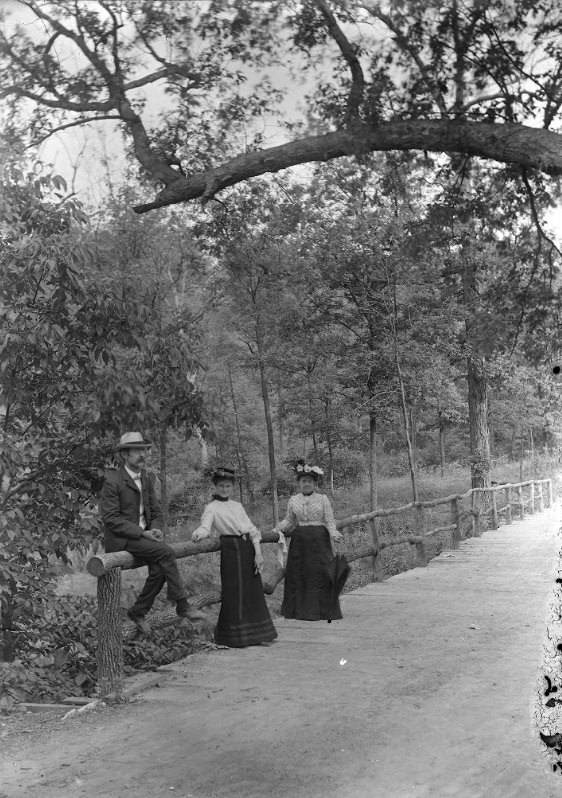 #126 Three People Leaning on a Wooden Railing, 1900
