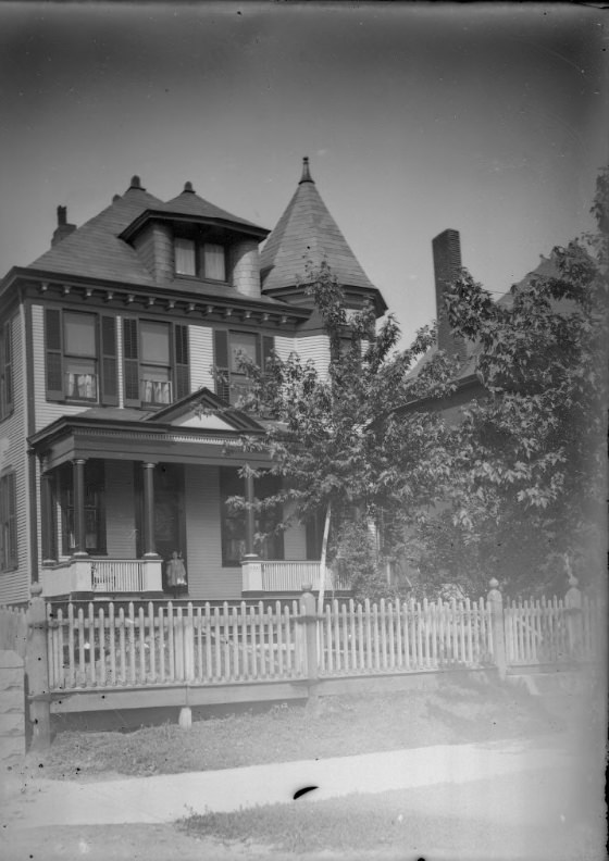 #144 Child Standing on the Porch of a Large House, 1900