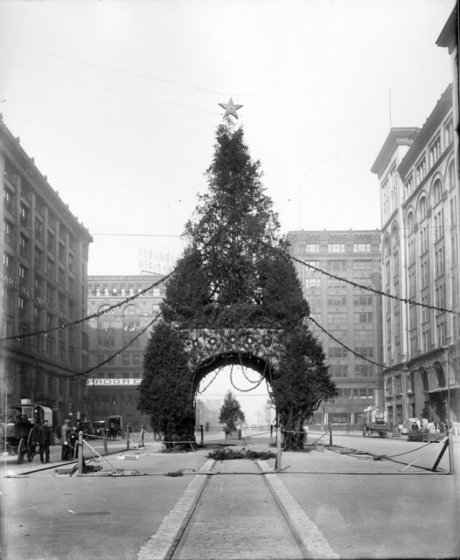 #46 A Christmas Tree arch display being set up on North Tucker Boulevard, 1900