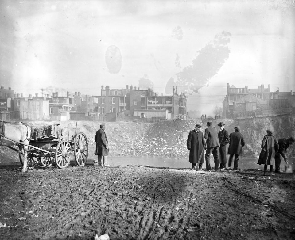 #88 Large pit in the middle of an urban area that is filled with water, 1900.