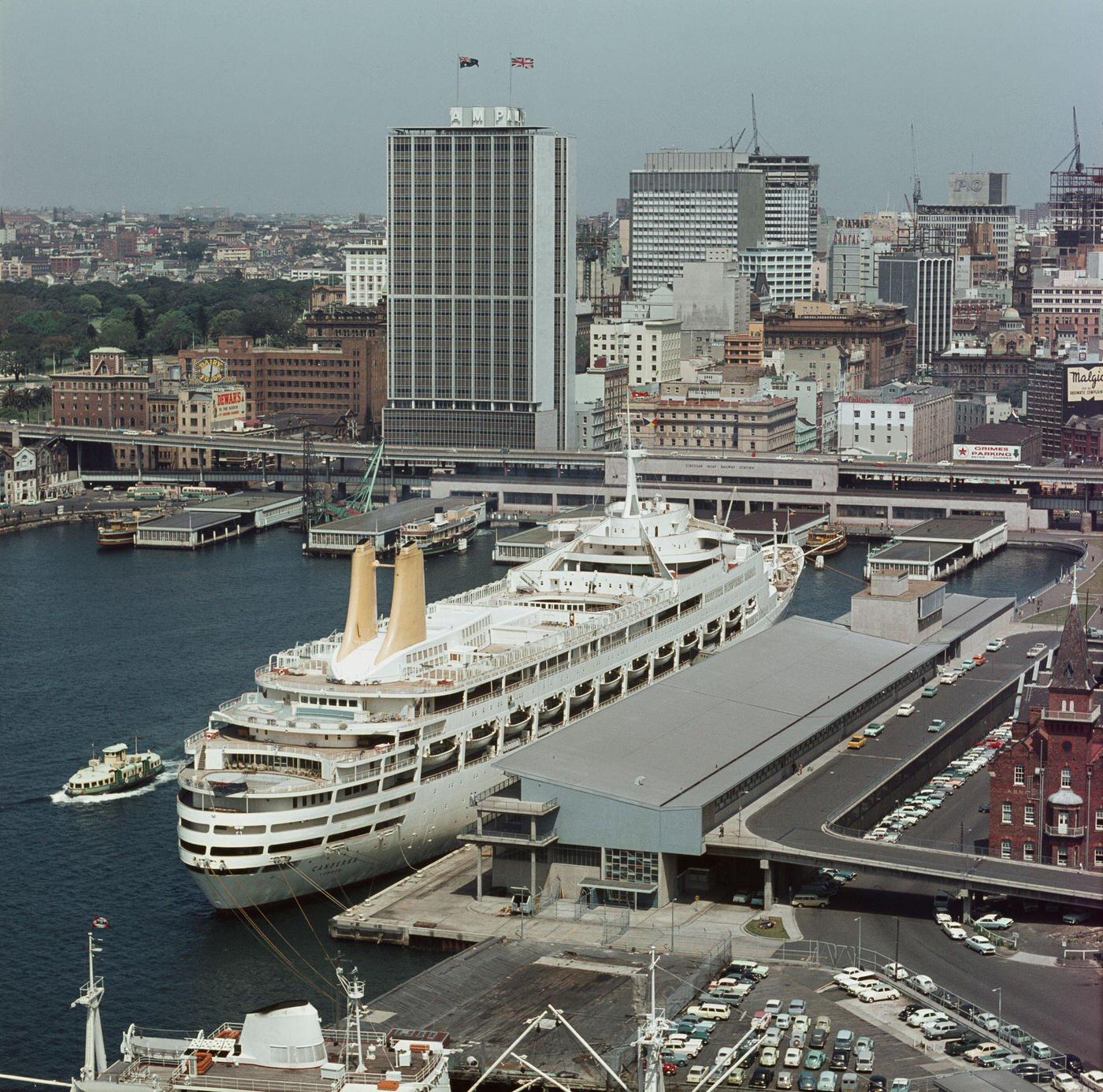 #86 View from Sydney Harbour Bridge of the Circular Quay wharves and Overseas Passenger Terminal underneath the recently completed AMP Building office block in downtown Sydney, 1960s