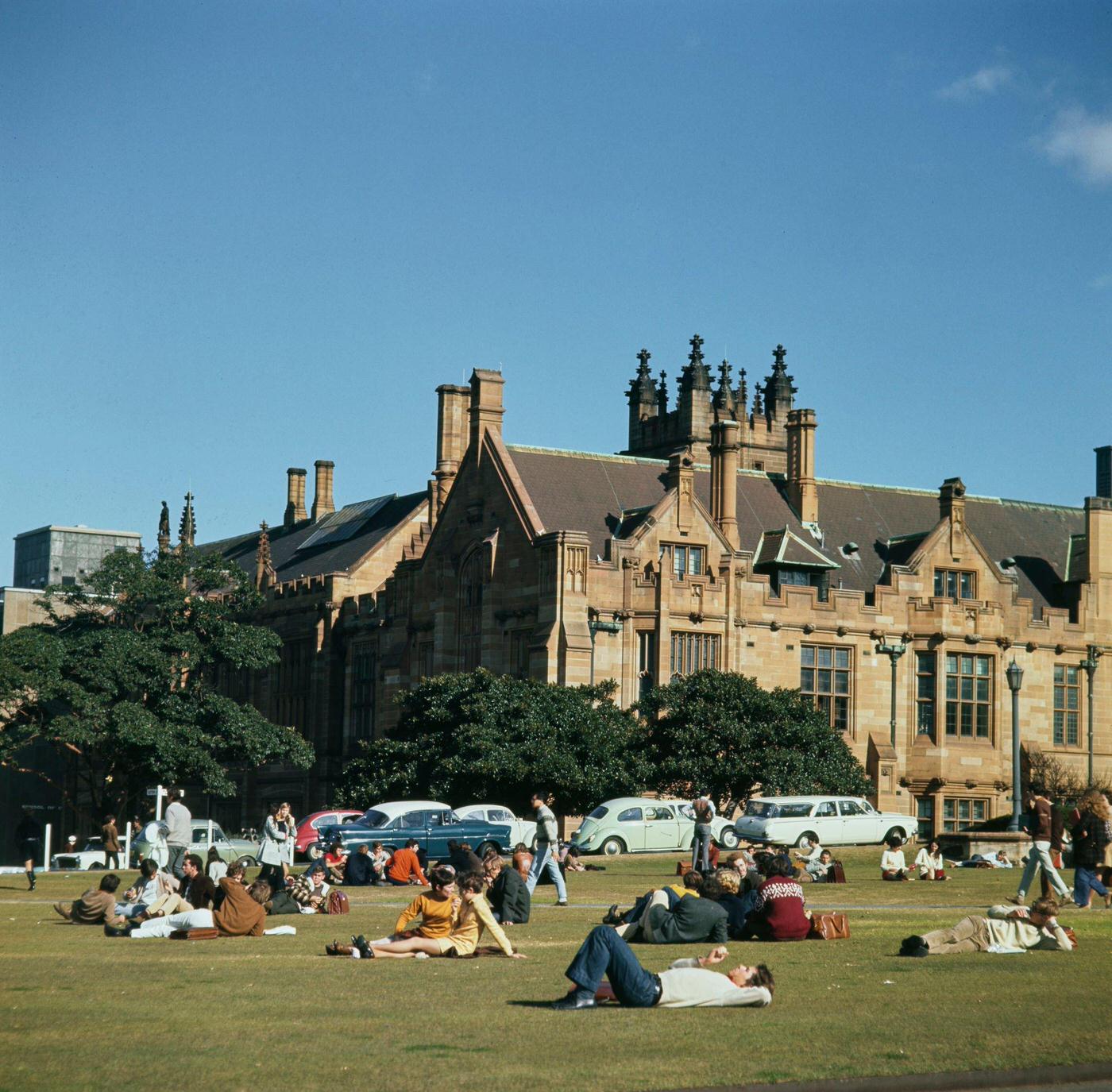 #93 Students relax on grass lawns in front of the Main Campus Building of the University of Sydney in the Camperdown district of Sydney in New South Wales, 1965