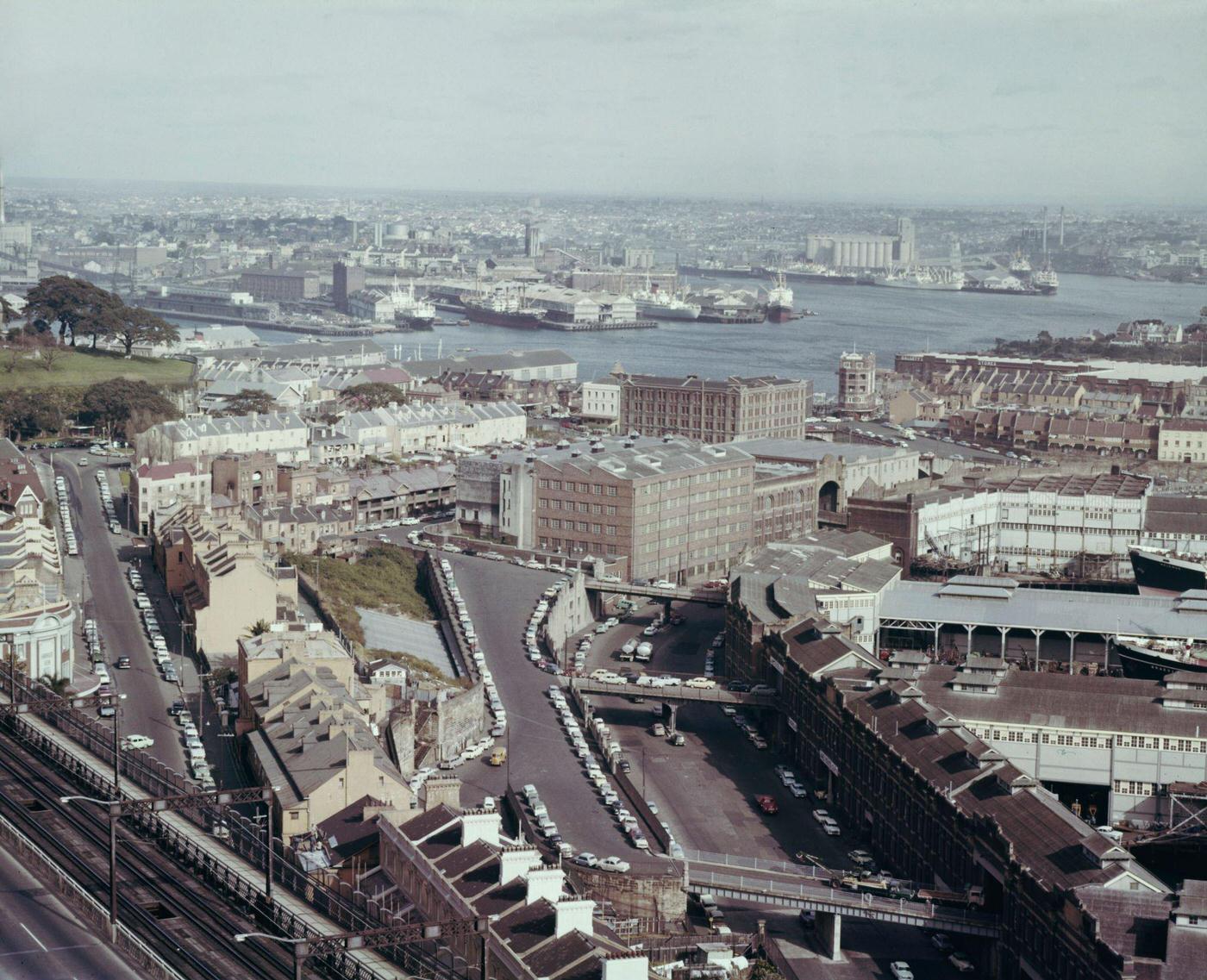 #96 View from the top of Sydney Harbour Bridge of ships moored at wharves alongside Hickson Road and Walsh Bay in the Dawes Point district of the city of Sydney, 1963