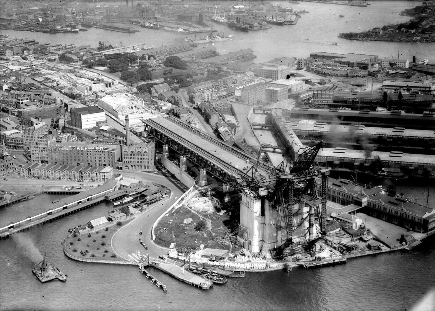 #41 Aerial view of the construction of the Sydney Harbor Bridge and its approaches.