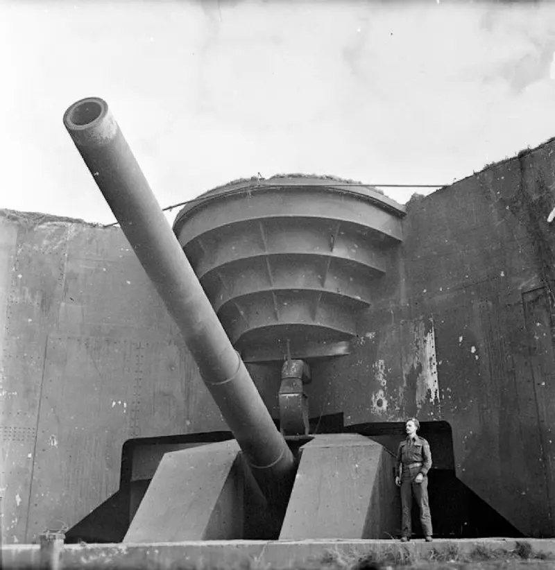 #2 A British soldier poses next to the recently captured German 380 mm gun Todt Battery at Cap Gris Nez.