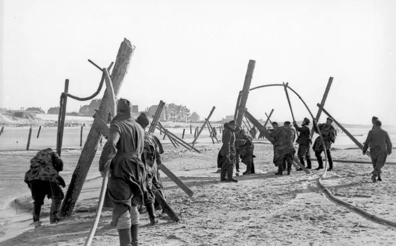 #5 German soldiers placing landing craft obstructions, 1943.