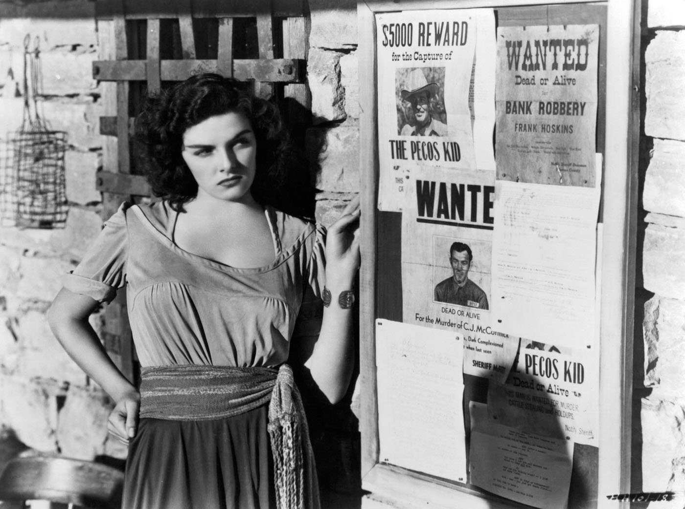 Jane Russell looking at ‘Wanted’ posters in a scene from the film ‘The Outlaw’, 1943.