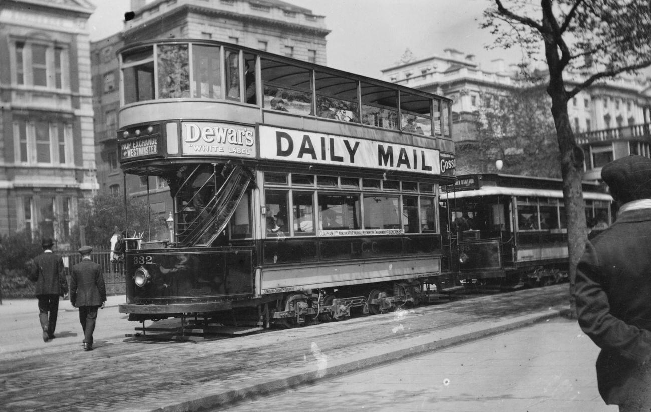 Double Decker London Tram Car has signs advertising Dewar’s Whiskey &; the Daily Mail Newspaper