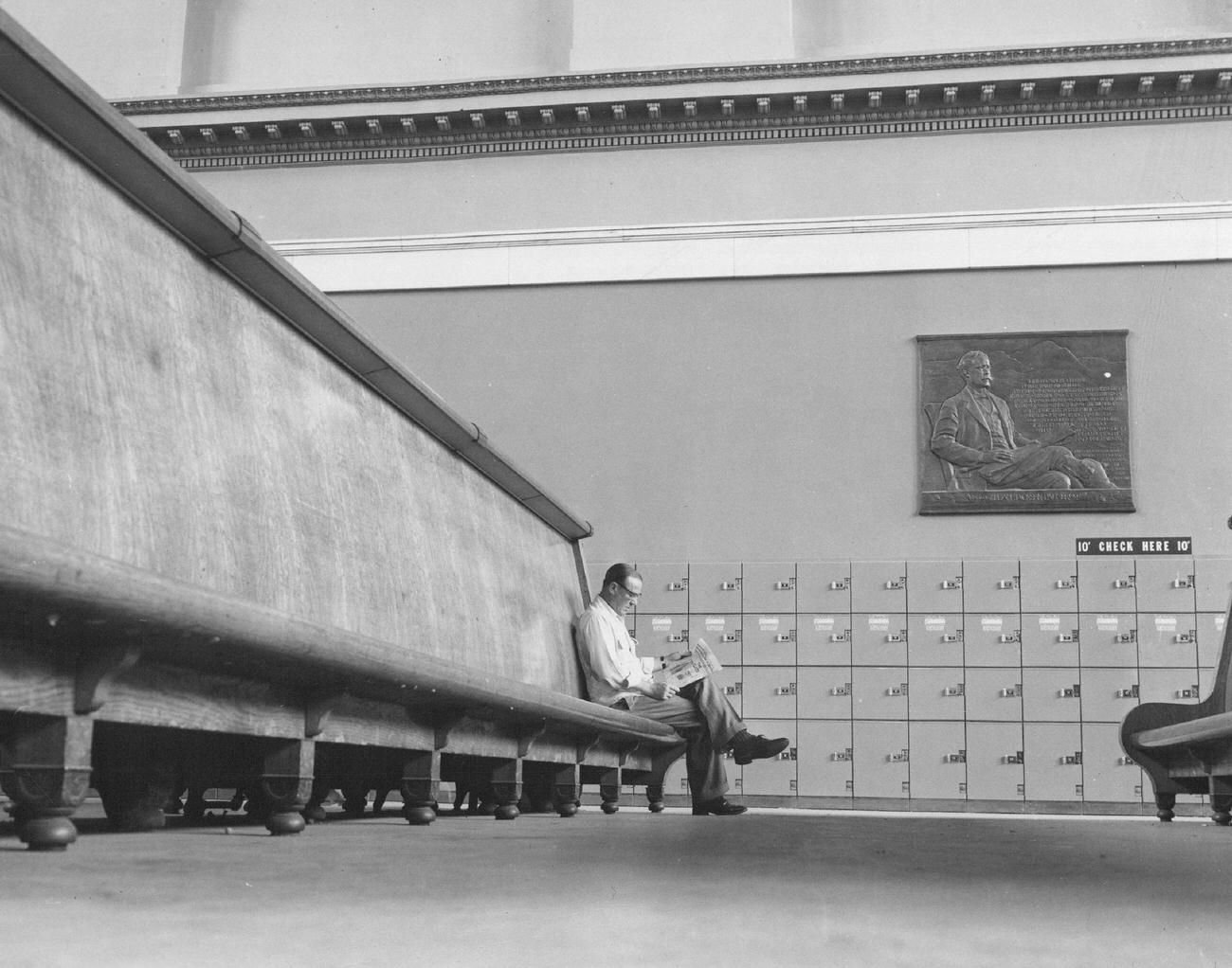 A lone traveler sitting in almost empty waiting room at Denver’s union station, 1953