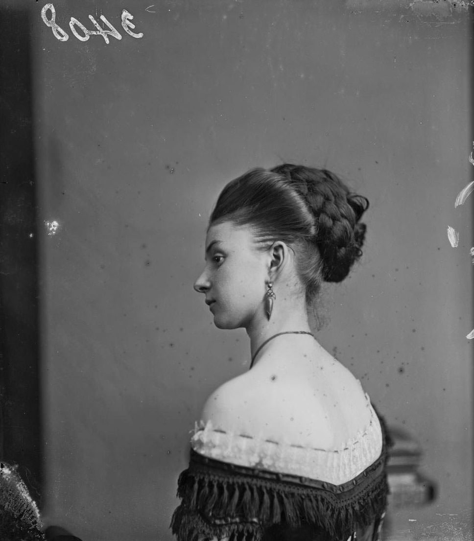 #6 Miss Cornell posing in an off-the-shoulder gown and with an elaborate hairstyle, London, 1880.
