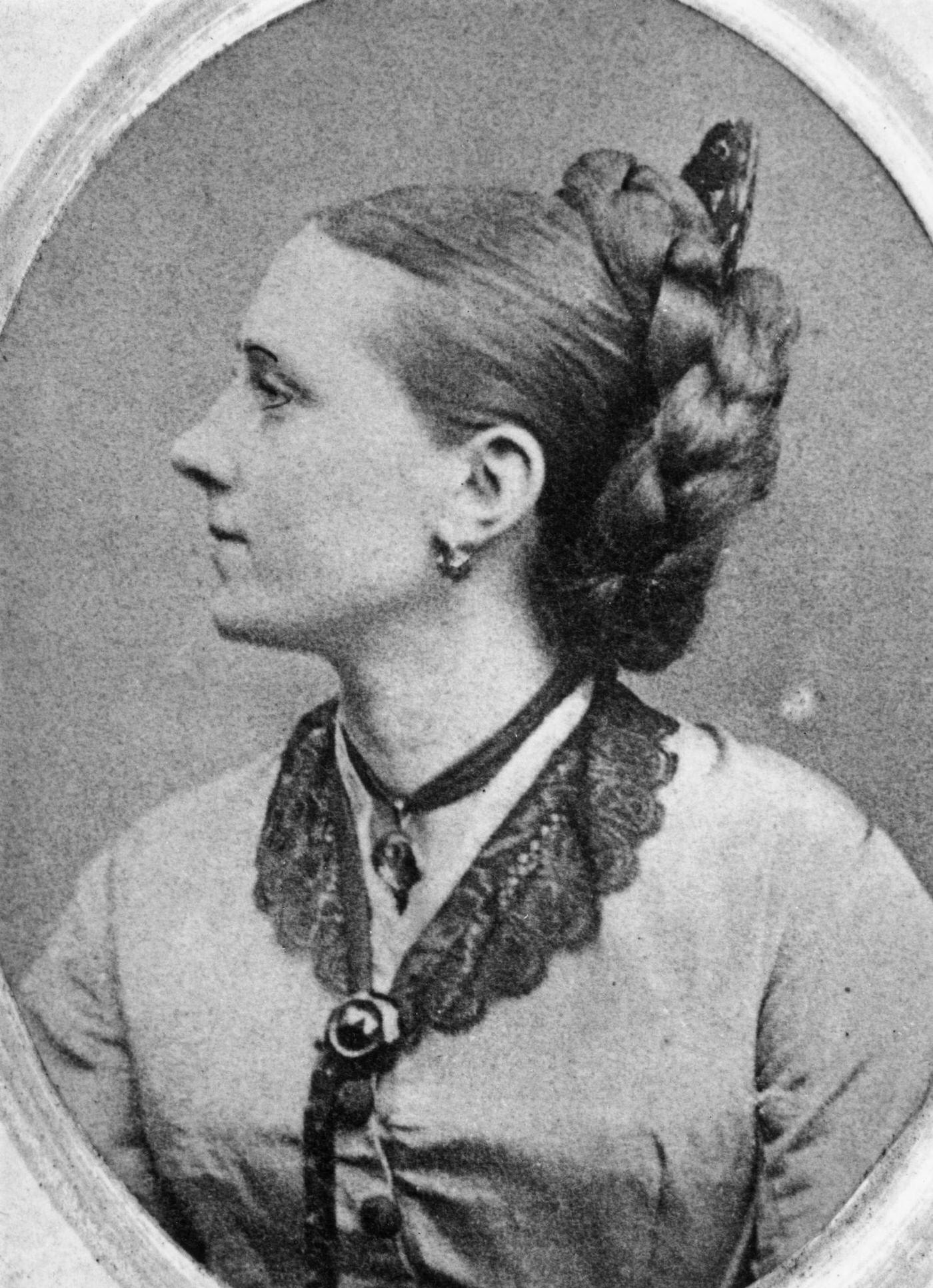 #7 A woman with her long hair braided and coiled behind her head, 1870