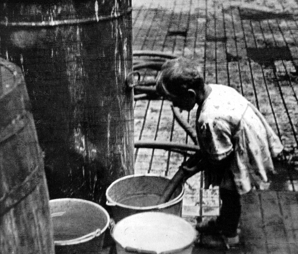 #13 A young girl collecting water.