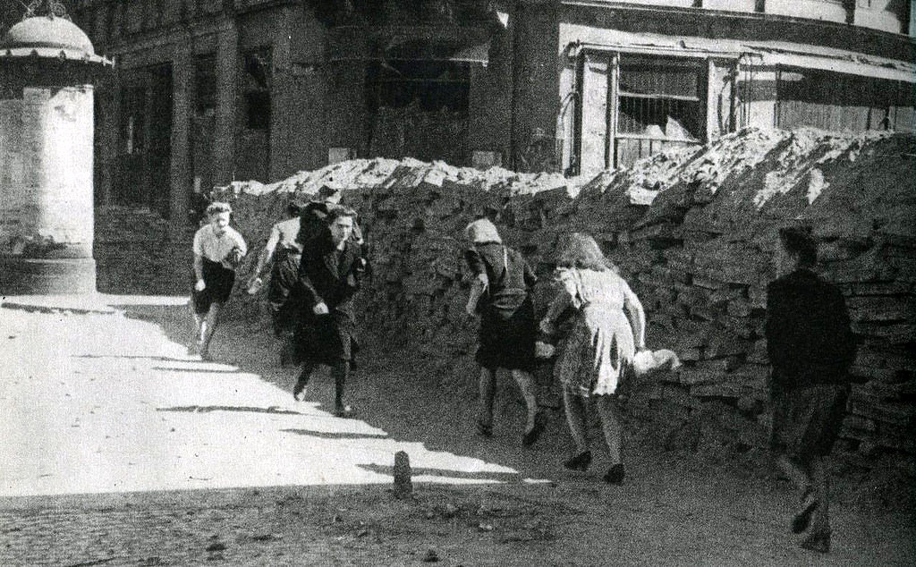 #33 People crossing Wielka Street behind a barricade under fire from Germans.