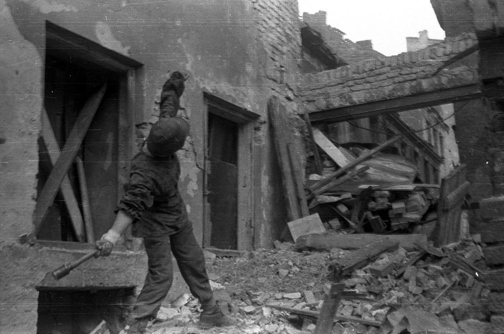 #4 A Polish partisan from Anna company of the Gustaw battalion, throwing a grenade towards German positions.