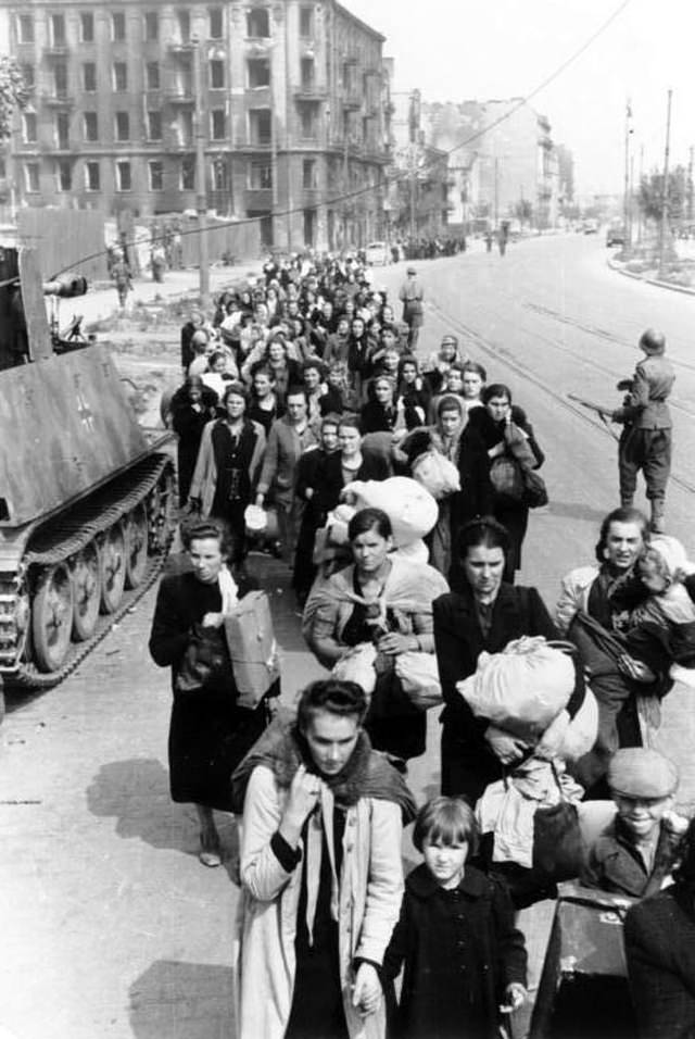 #44 Residents of the Wola district being marched down Wolska Street after being expelled from their homes.