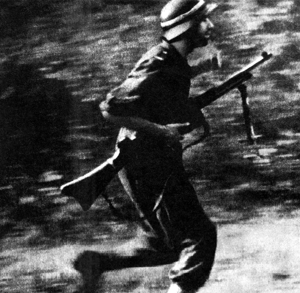 #6 A Polish partisan of the Baszta battalion on the move.