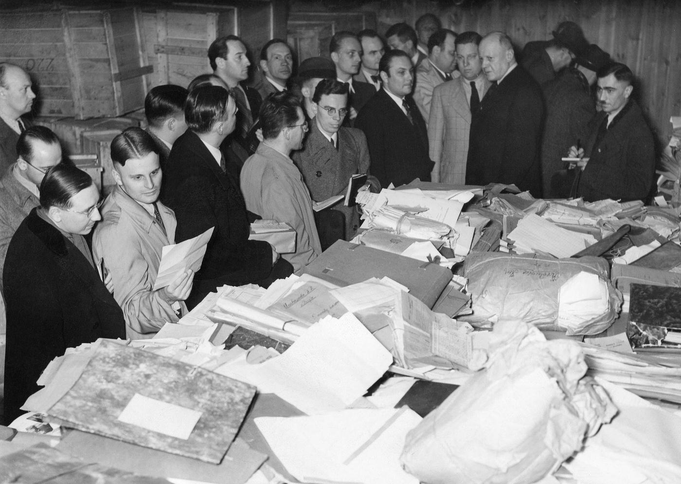 #68 This photograph shows journalists examining documents belonging to the Polish secret service that were captured at the Polish Ministry of Foreign Affairs in Warsaw.