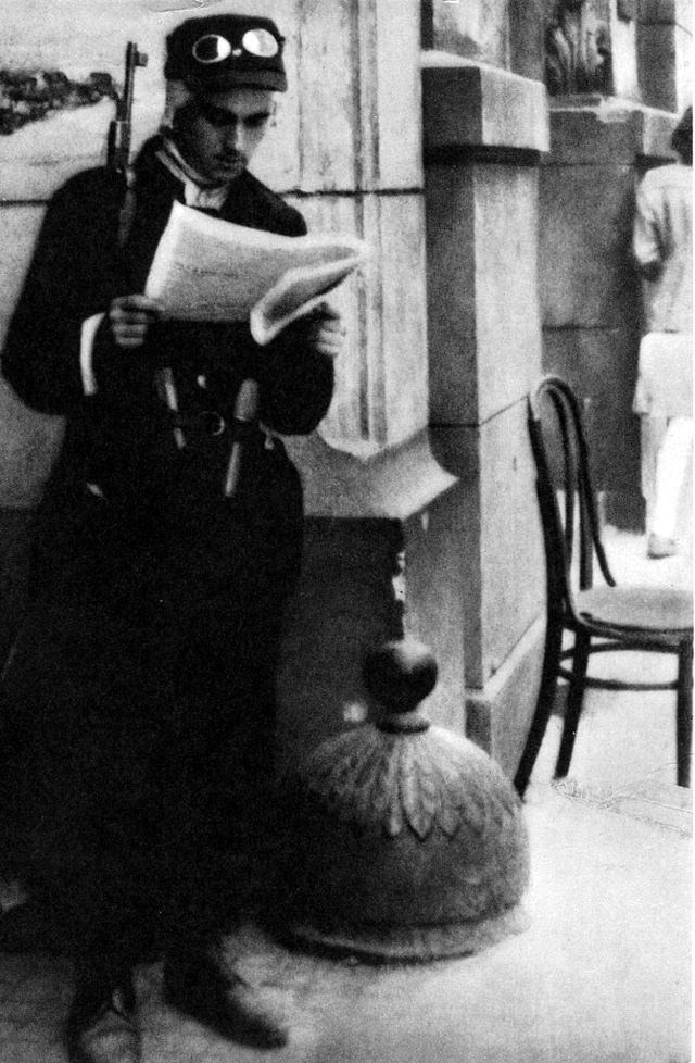 #8 A Polish partisan reading an insurgent newspaper.