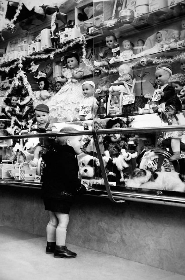 #20 A little boy looking at a Christmas shop window display in Rome, 1957.
