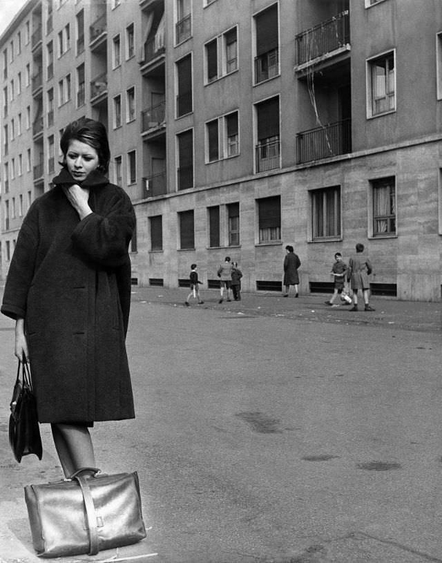 #26 A young woman trying to protect herself from the cold during winter, 1961. (Walter Mori)