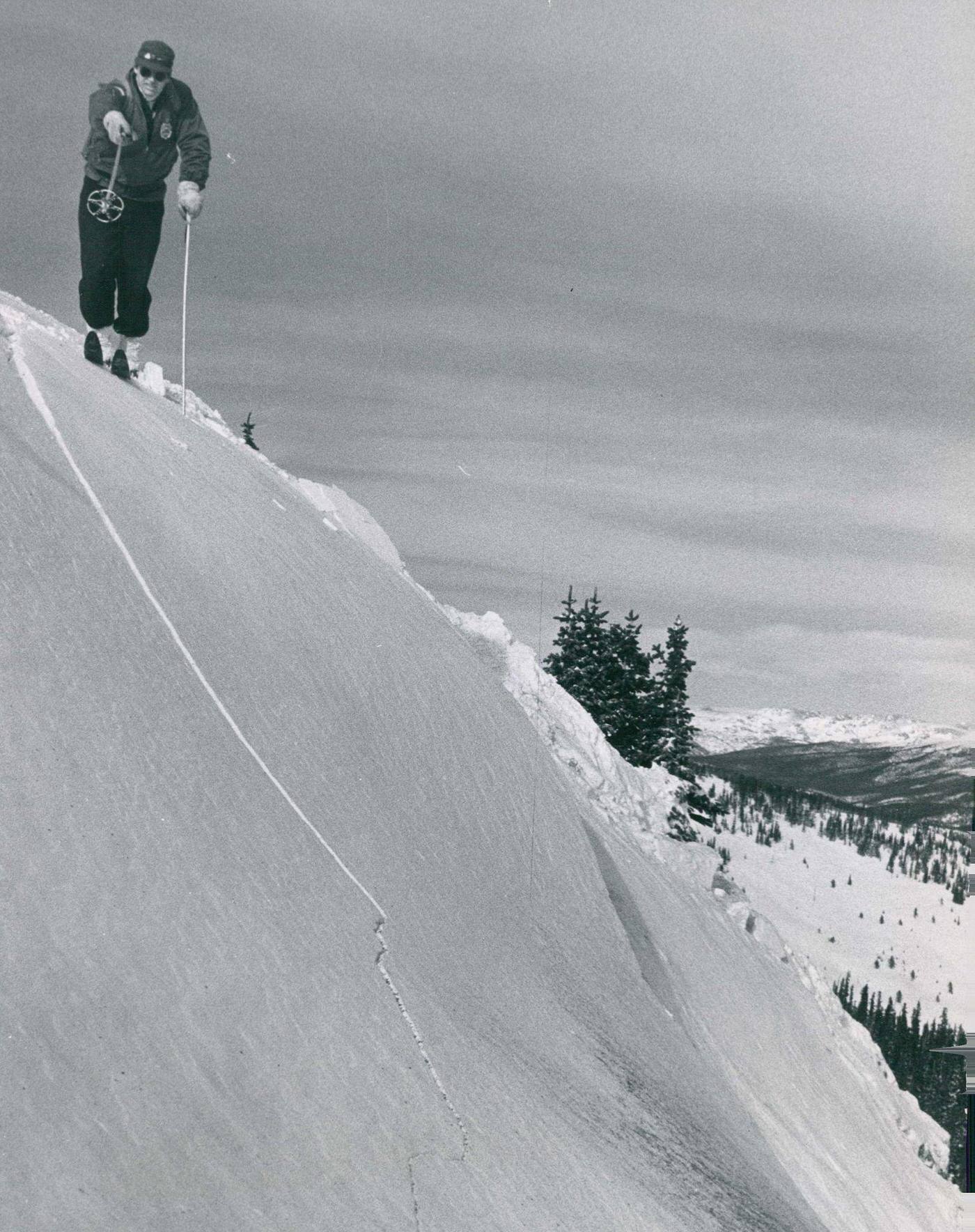 #30 Dick Stillman, “avalanche buster” for the U.S. forest service atop Berthoud Pass, points out jagged fracture line in the snow.