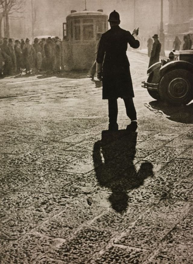 #4 A watchman runs the traffic on a sunny winter morning, Milan, 1934.