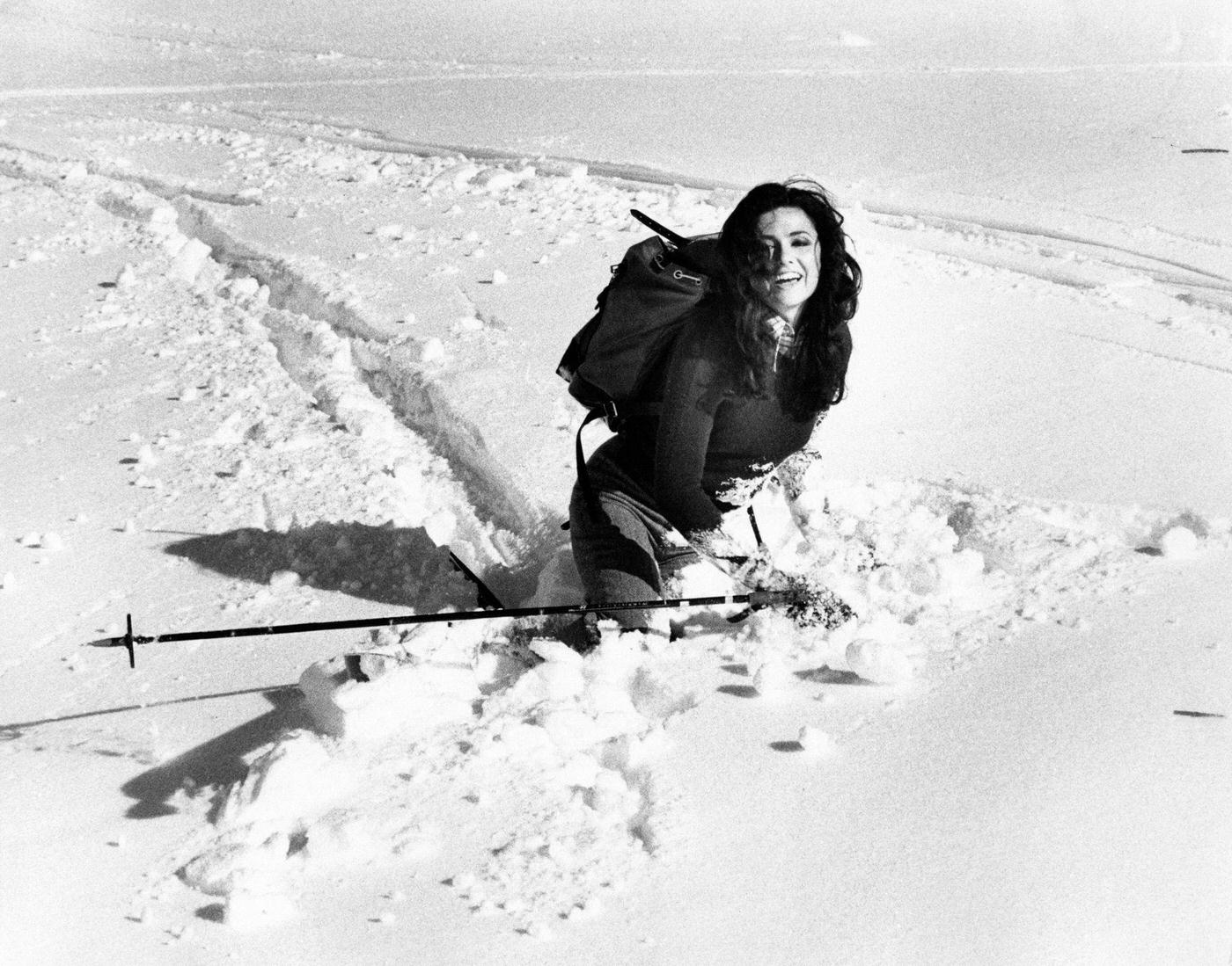 #44 Italian singer Gigliola Cinquetti playing on the snow with a ski stick in her hand. San Giorgio, 1974.