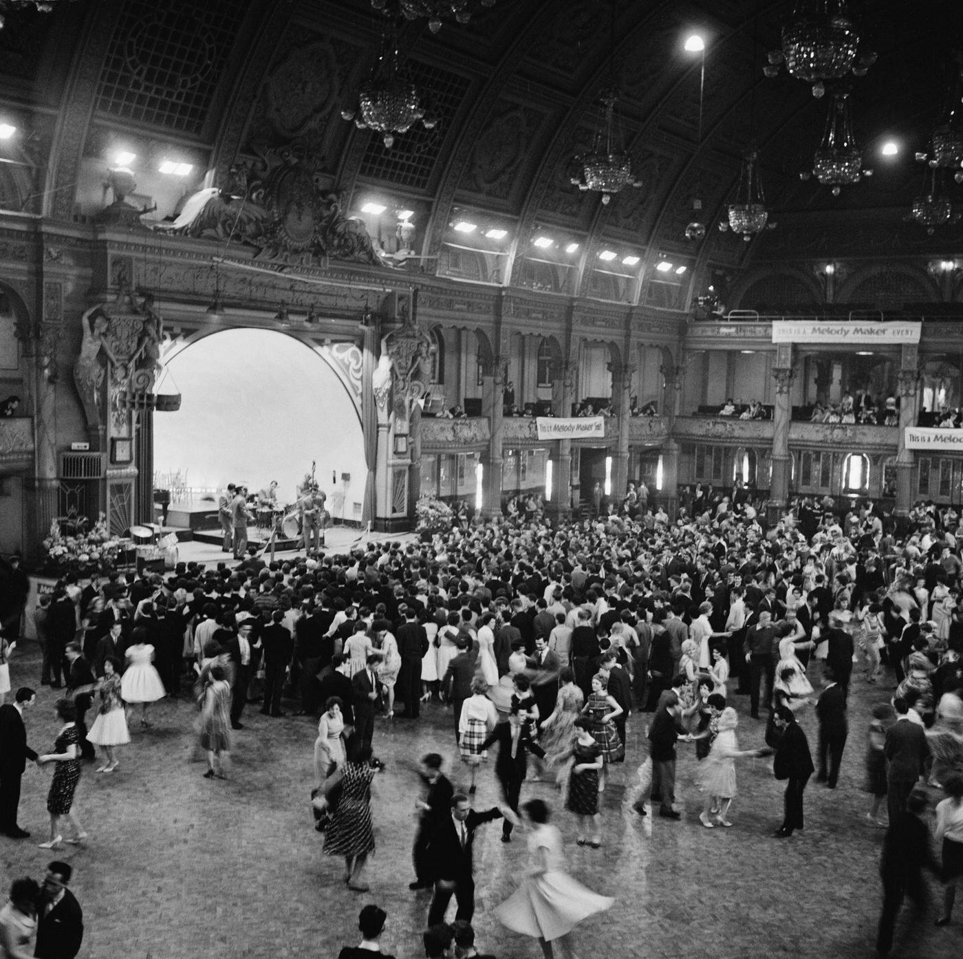 #40 View of dancers and audience members on the dancefloor being entertained by a jazz band on stage at the Winter Gardens venue in Blackpool, Lancashire during the Melody Maker Festival in June 1961.