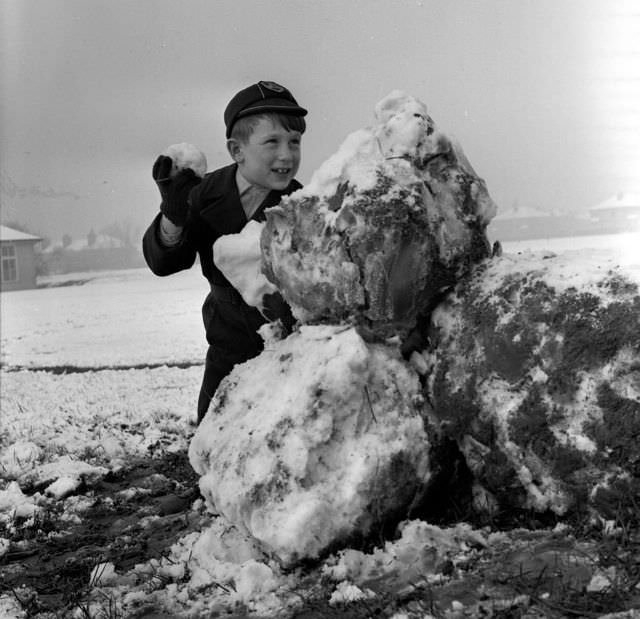 #18 A boy about to throw his snowball, 1961.