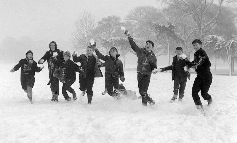 #23 Children on holiday from school throwing snowballs on Tooting Bec Common, 1962.