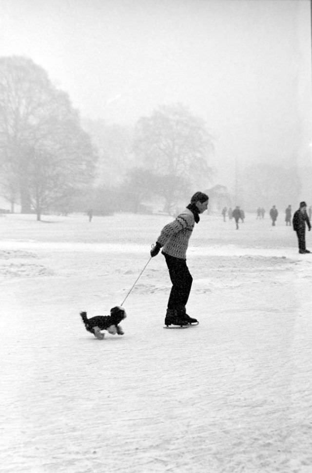 #31 A man and his dog ice skating on a frozen lake near London, 1963.