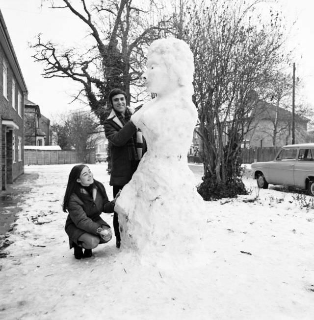 #38 A couple building their snow-woman, 1969.