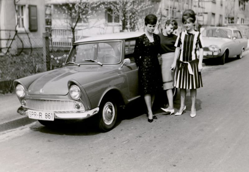 #10 Three stylish ladies posing with a DKW Junior in a residential street. The car is registered in the West German town of Springe, 1962