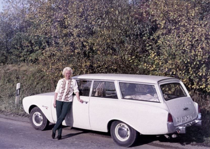 A platinum-blonde lady posing with a Ford Taunus 17M Turnier on a sunny autumn’s day. The car is registered in the West German town of Oldenburg, 1965