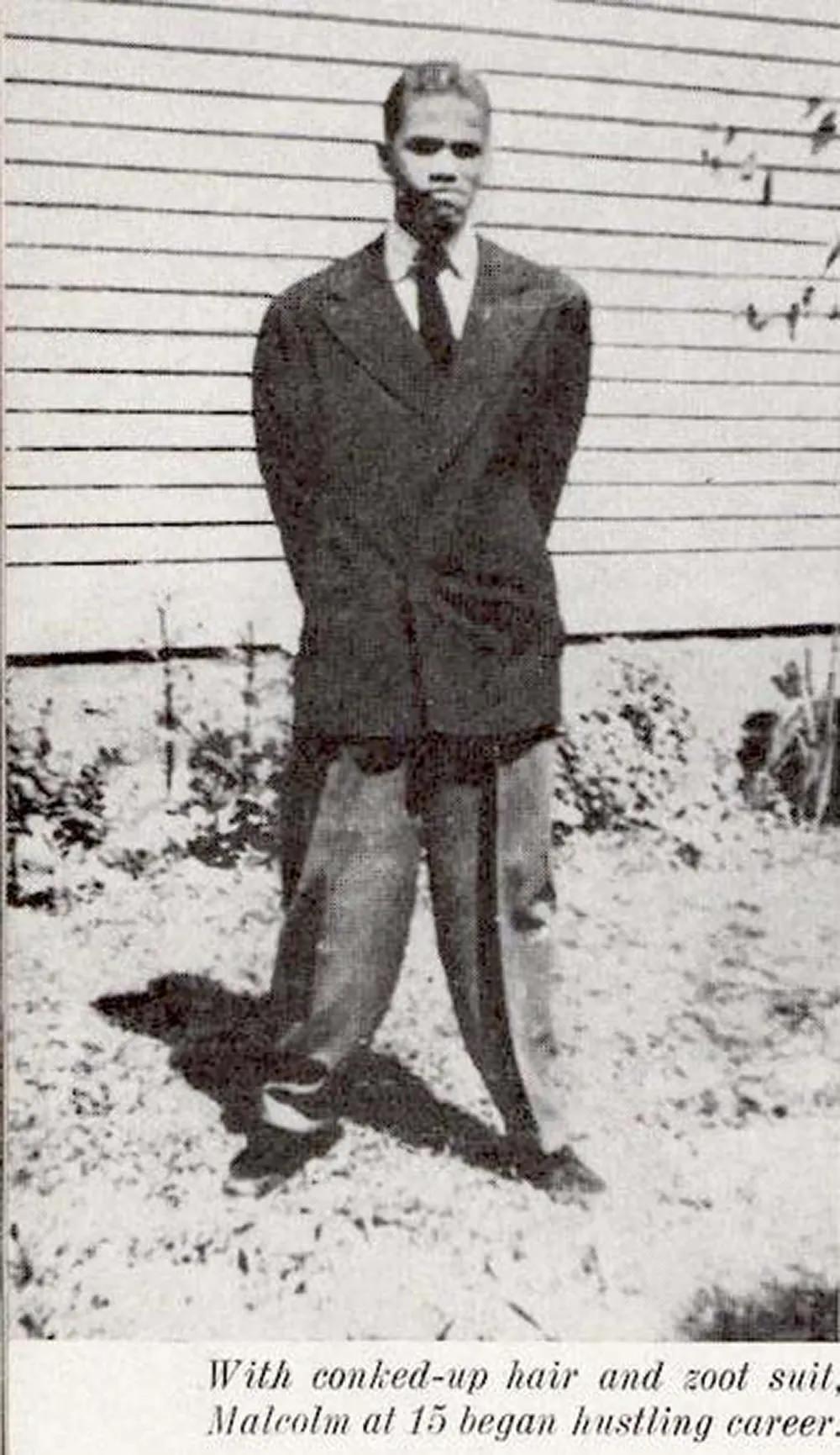 #11 Malcolm X wearing a zoot suit.