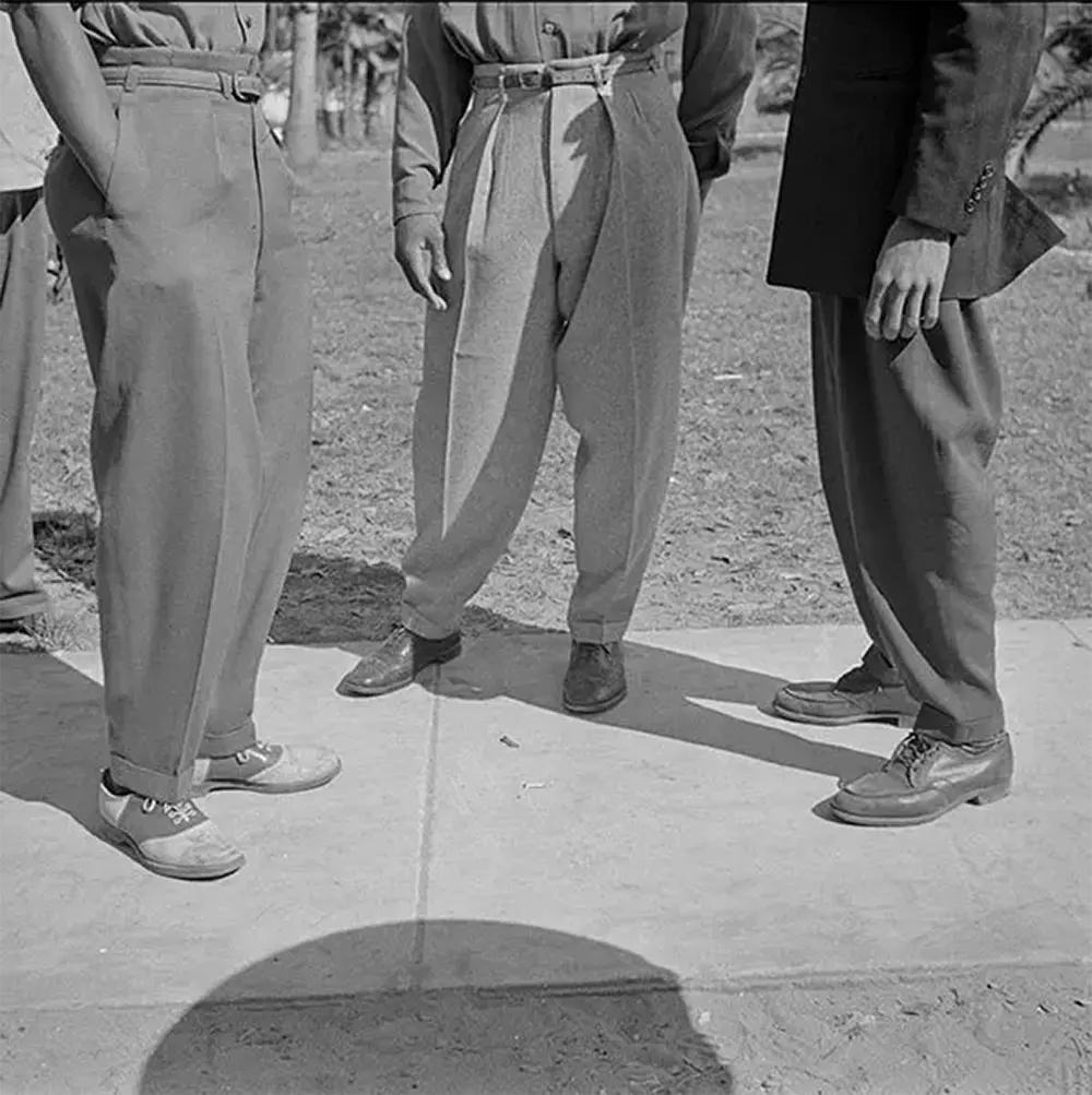 #13 Zoot suit pants legs were wide and tapered at the ankles. The noted photographer Gordon Parks captured this image in Daytona Beach, Florida.
