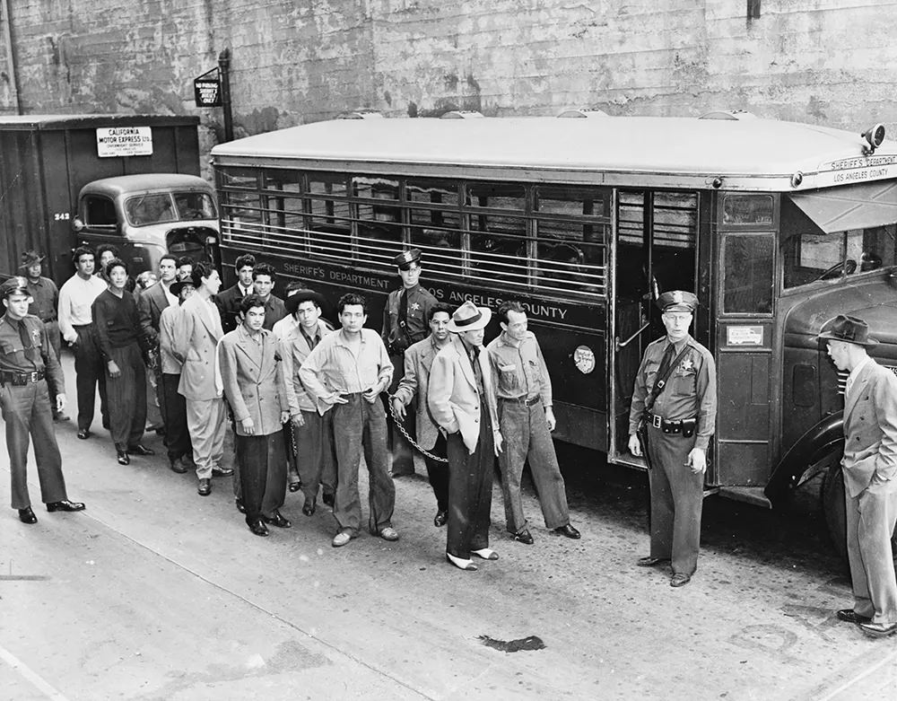 #2 Mexican American “Zoot suiters” lined up outside Los Angeles jail en route to court.