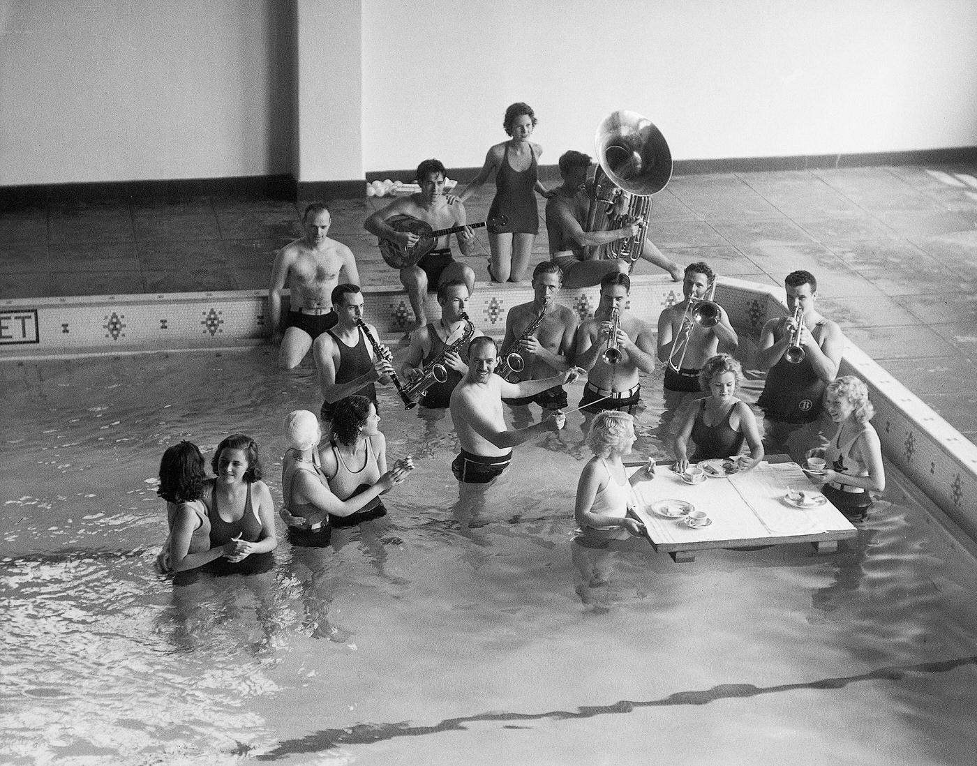 #105 Jazz band playing in the swimming pool at the Santa Monica Hotel. There are girls eating and dancing as well – June 19, 1933.