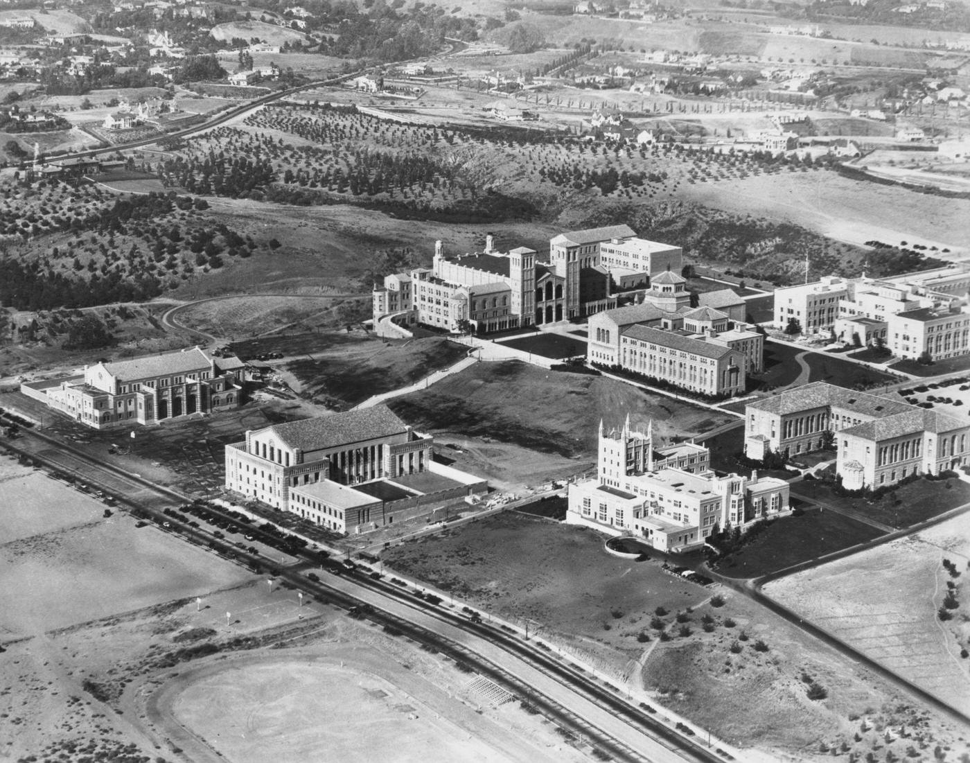 #130 Aerial view of the Westwood campus of the University of California, with the Royce Hall building (top, centre), Kerckhoff Hall (bottom, right) in the Westwood neighbourhood of Los Angeles, 1934.
