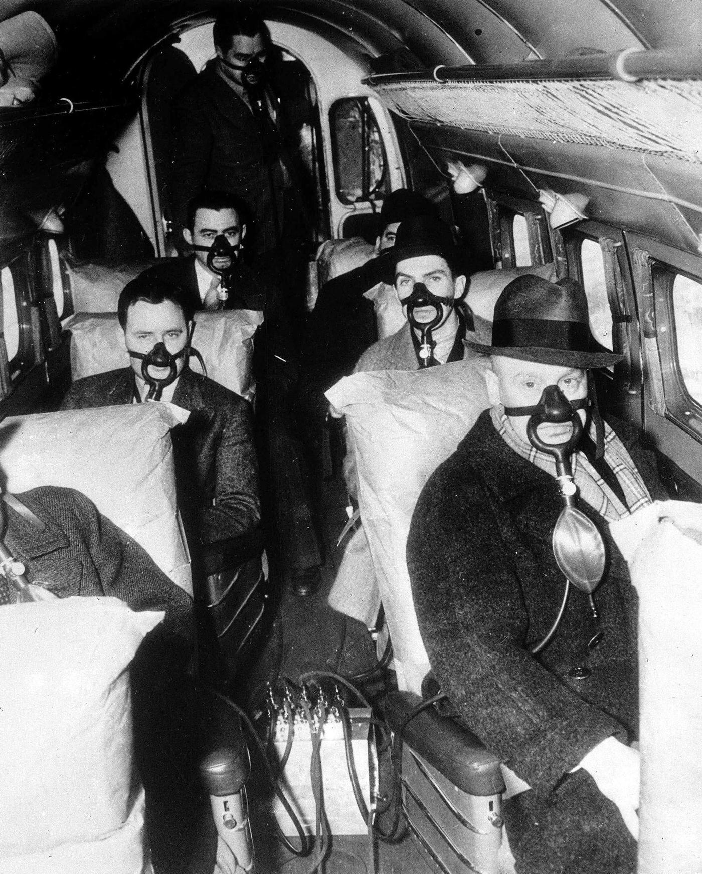 #17 American Airline passengers make the first stratosphere flight test. The picture shows passengers breathing through their special masks during the flight.