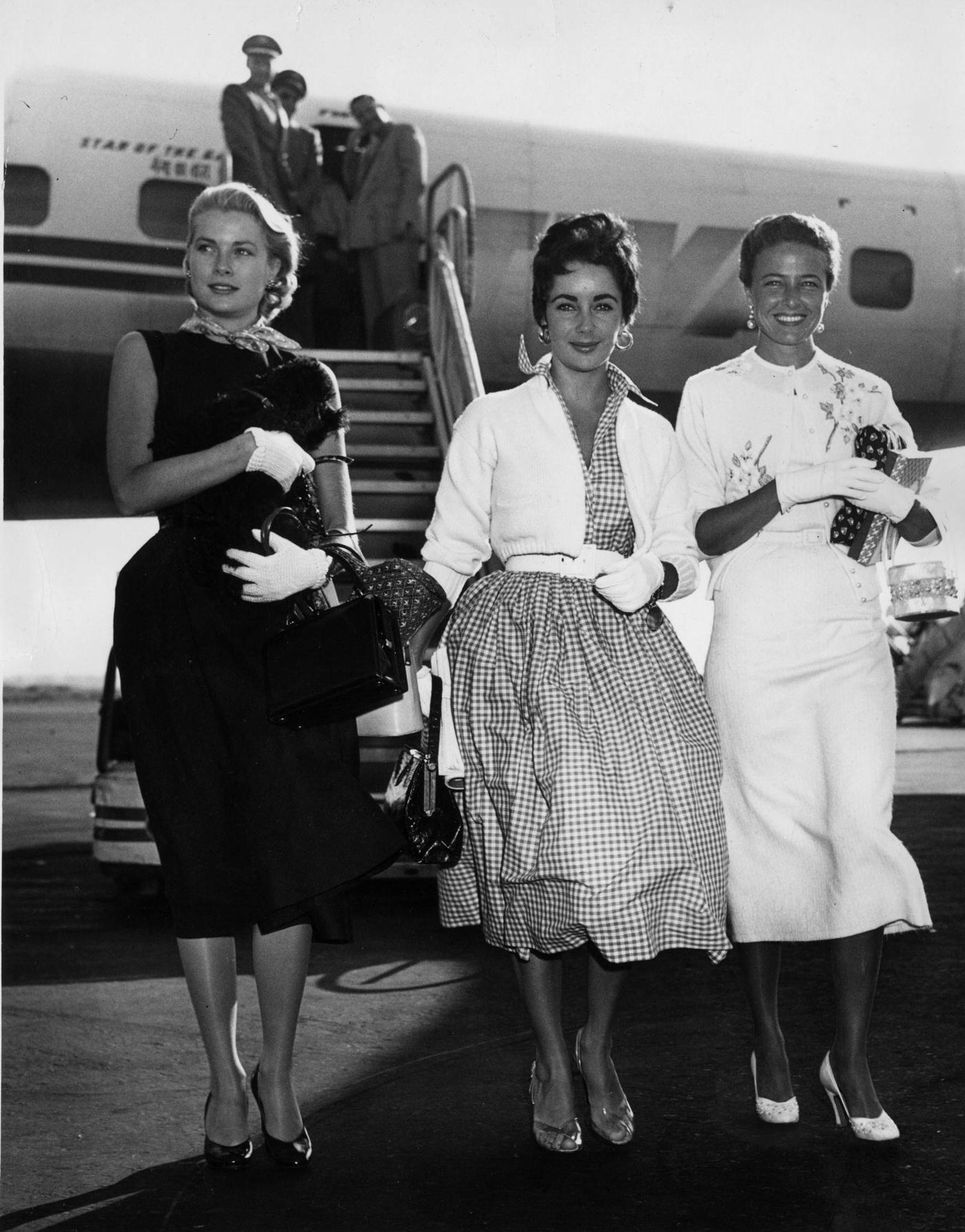 #88 Britishborn American actress Liz Taylor arrives at New York International Airport with fellow actresses Grace Kelly and Lorraine Day in 1955.