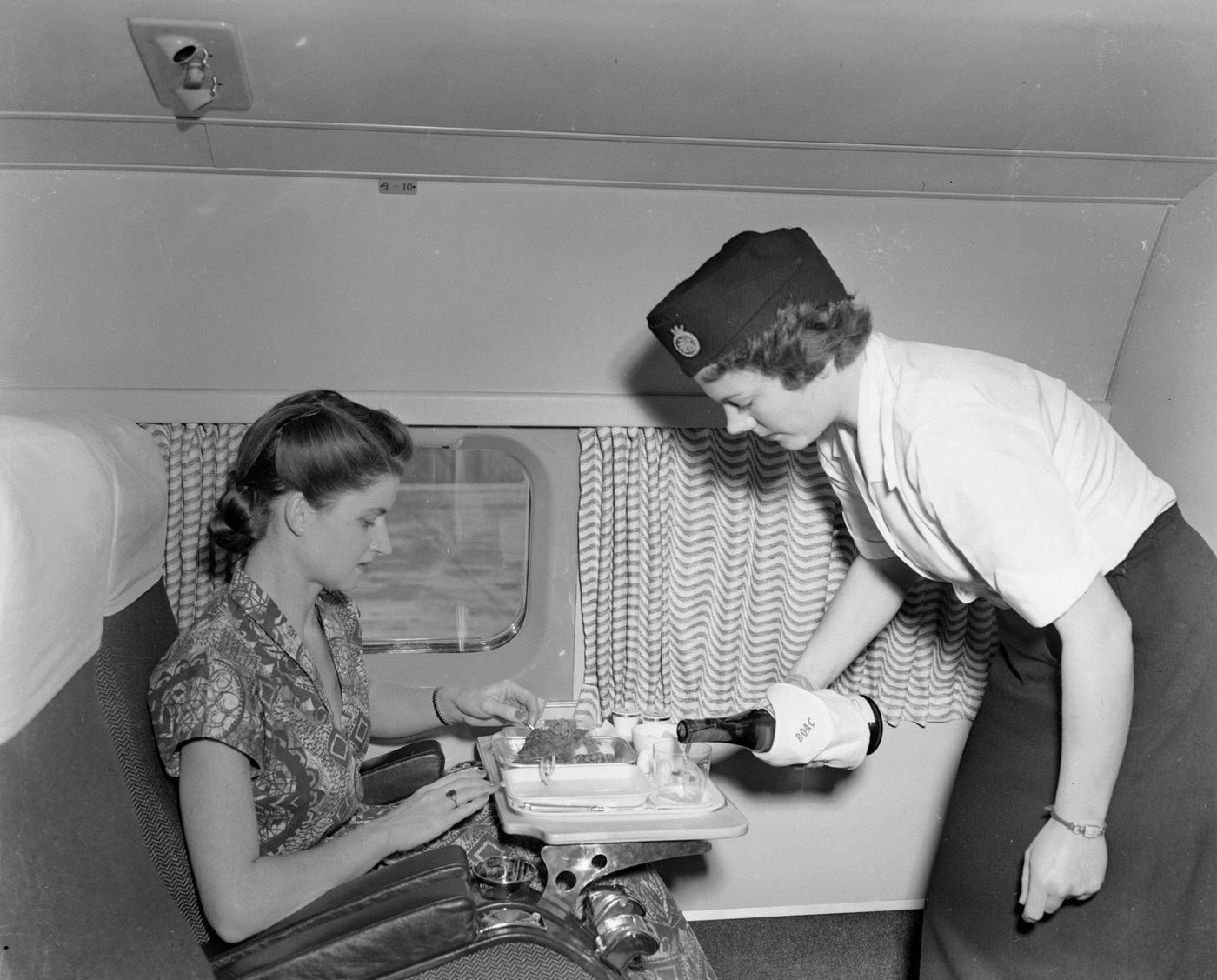 A passenger on board the world’s first jet airliner service receives luncheon from E Courtney, a member of the cabin crew. The Comet flight is headed for South Africa.