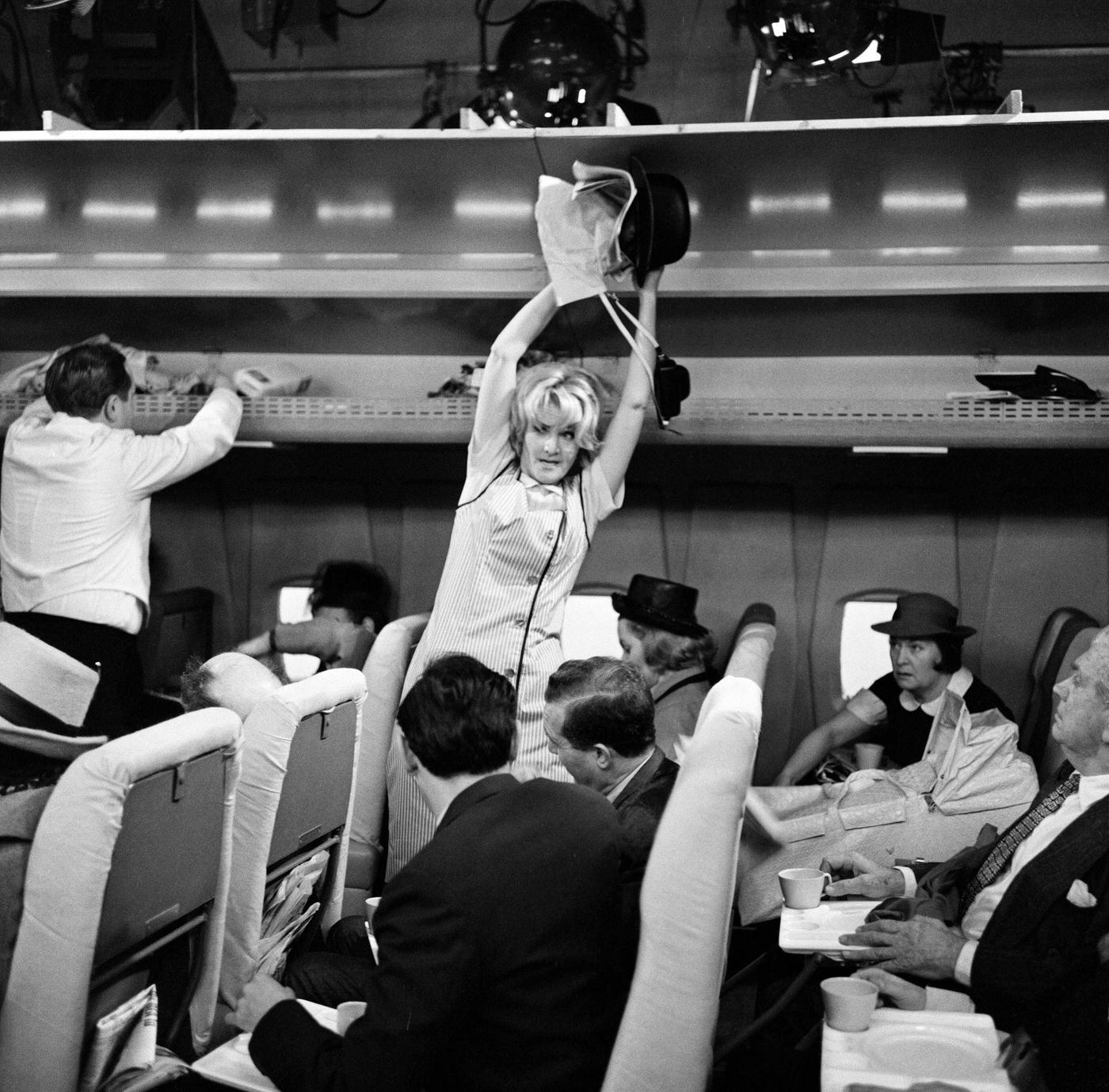 Sheila Hancock playing the role of an air hostess in scenes being shot for the comedy series “The Bed-Sit Girl” at BBC Studios on February 21, 1965.