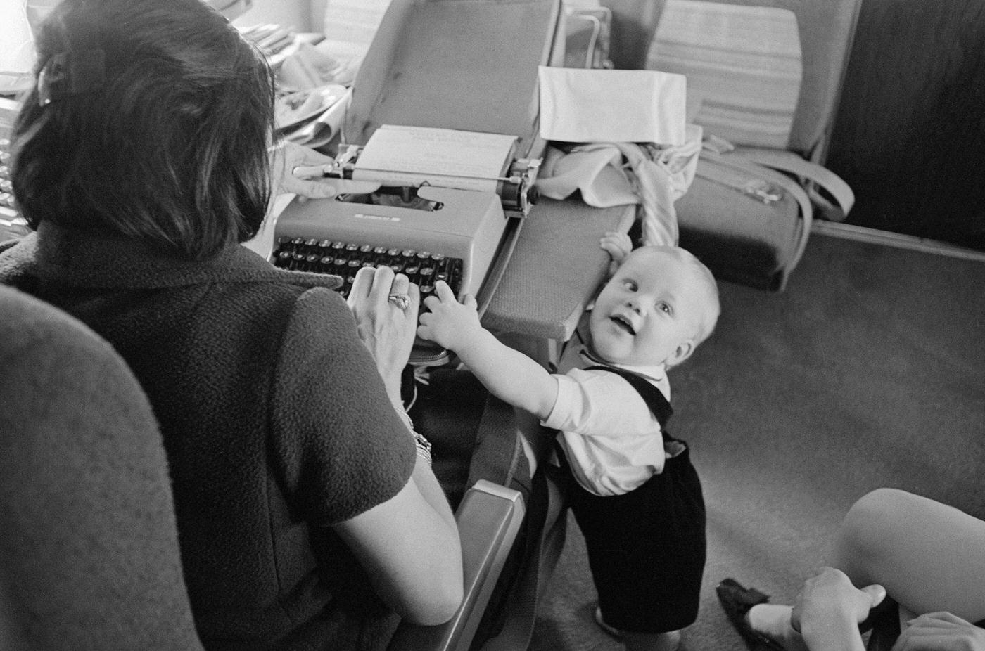President Lyndon Johnson’s grandson, Patrick Lyndon, typing on a typewriter with journalist Helen Thomas on Air Force One during a flight to New York City in the 1960s.