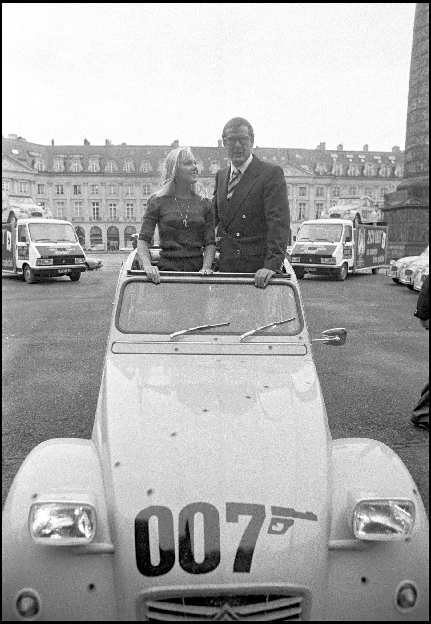 Roger Moore promoting “For Your Eyes Only” with a Citroen 2CV on Vendome Plaza in Paris.