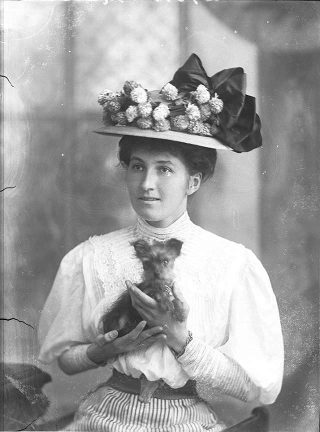 #116 Miss Marston poses with her dog for a portrait on October 1, 1908