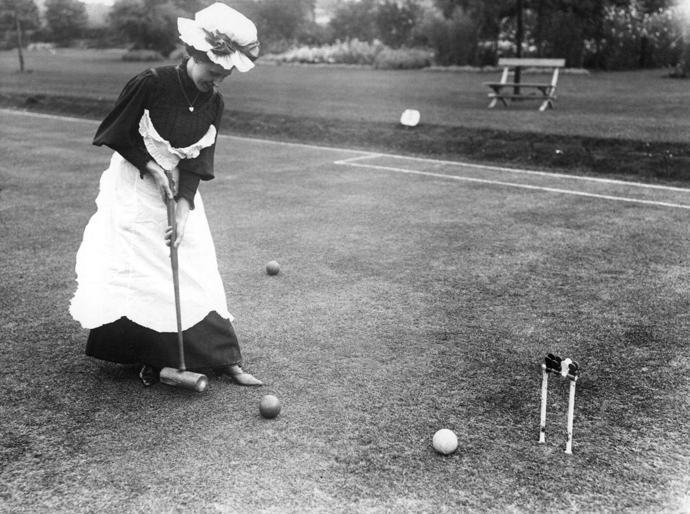#29 A group of Edwardian ladies and gentlemen playing croquet on a sunny day